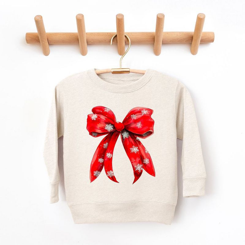 سويت شيرت جرافيكي ناعم للغاية للشباب من Juniper Shop Coquette Christmas Snowflake Bow