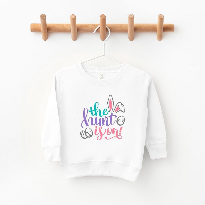 The Juniper Shop The Hunt Is On Easter Toddler Graphic Sweatshirt