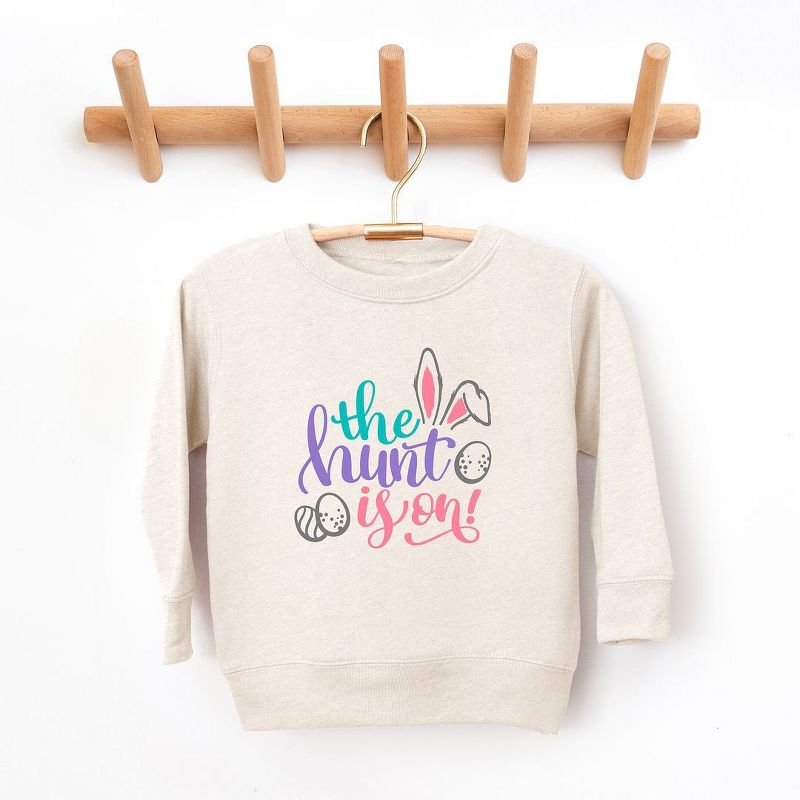 The Juniper Shop The Hunt Is On Easter Toddler Graphic Sweatshirt