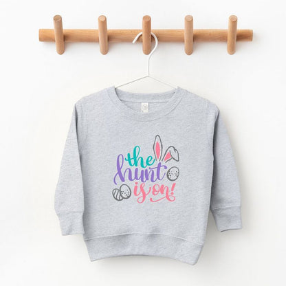 The Juniper Shop The Hunt Is On Easter Toddler Graphic Sweatshirt